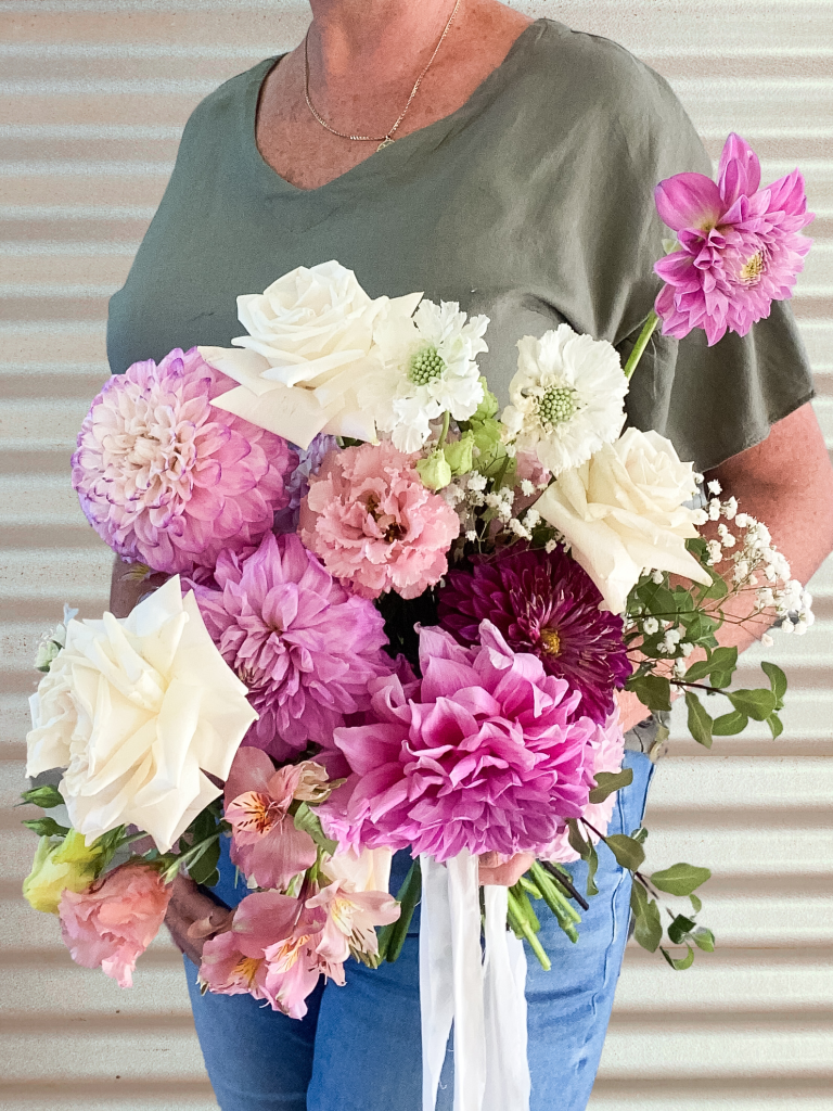 A beautiful wedding bridal bouquet using show standard Dahlia flowers. Designed by Tania Guest, local florist from The Seasonal Bunch in Happy Valley, SA. Design name ‘Summer Lovin’