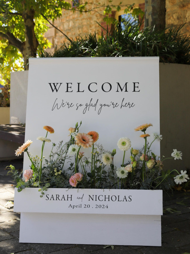 A stylishly beautiful Flower Box Welcome sign for weddings and other special occasions, with laser cut acrylic lettering and florals to suit any aesthetic from The Seasonal Bunch florist in Happy Valley SA